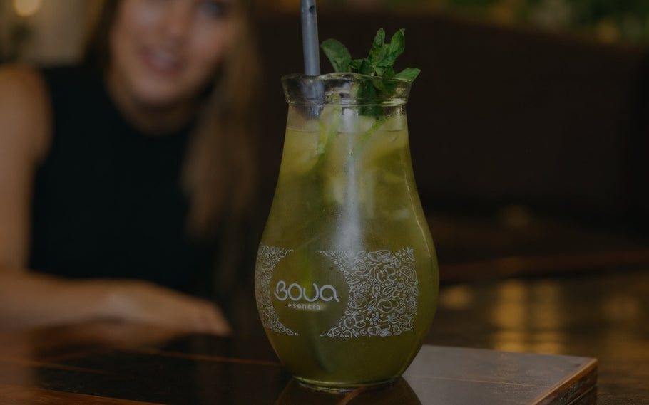Sangria BOUA Esencia com gelo, lima e hortelã numa jarra de vidro.
